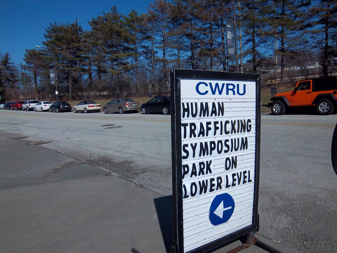 Photo of a sign pointing to a training symposium